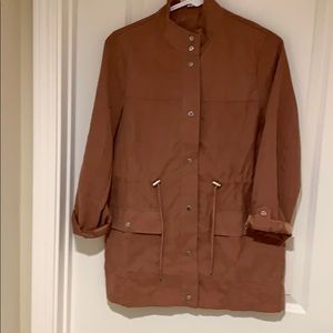 Rose colored jacket with some brown tones.